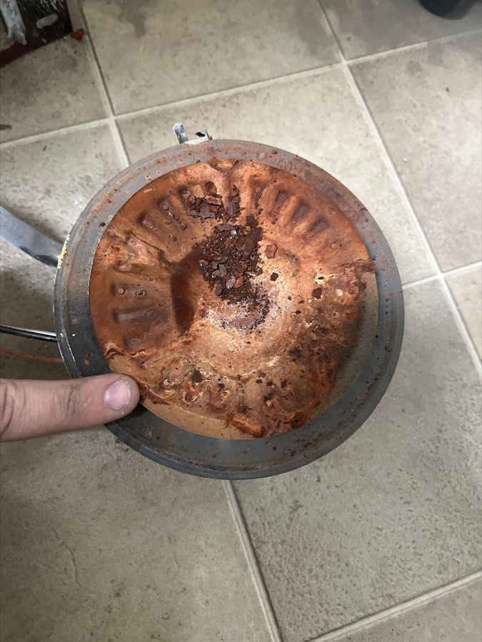 Heavily rusted plate from a gas water heater