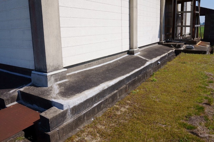 Patched cracks along a concrete foundation wall
